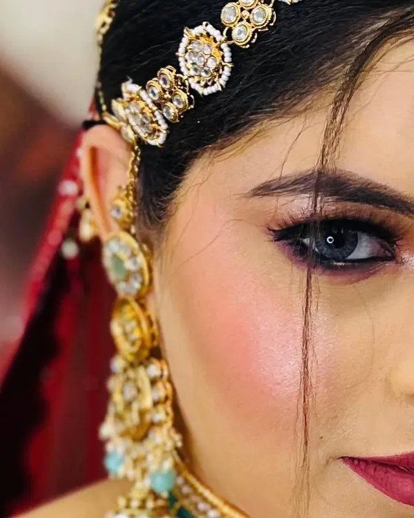 A stunning close-up of the eye. This half-face shot highlights the flawless blending, sharp liner, and the way makeup can accentuate eye color.