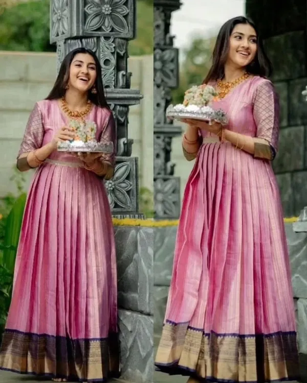 A full view of this gorgeous gown, upcycled from a traditional silk saree. The design retains the original border at the hem while creating a modern, flowing silhouette with elegant pleats.
