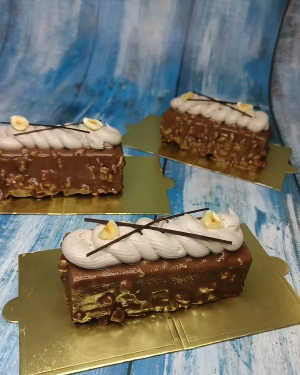 Beautifully crafted Hazelnut Mousse pastries from our international cakes class. Learn to create these layered desserts with a crunchy base, smooth mousse, and elegant toppings.