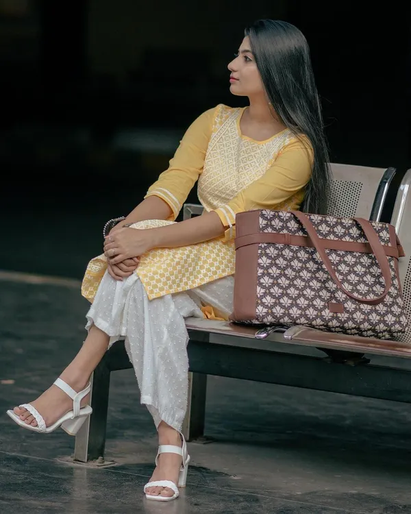 Modeling a stylish and functional laptop bag from Zouk. The pose is natural and confident, showing how the bag fits into a modern, on-the-go lifestyle.