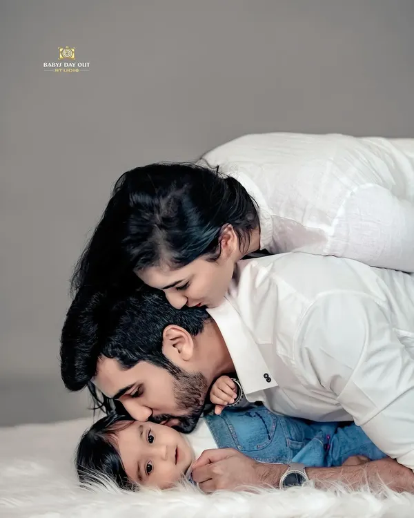 We believe the purest love is found in these quiet moments. This beautiful family portrait, with everyone in classic white, lets their deep connection be the absolute focus.