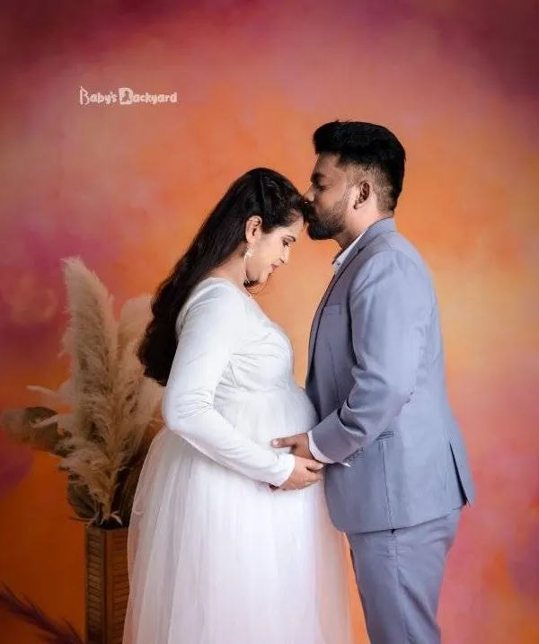 A gentle kiss on the forehead, a hand on the bump. These are the quiet, tender moments of connection we love to capture for expecting couples in our studio.