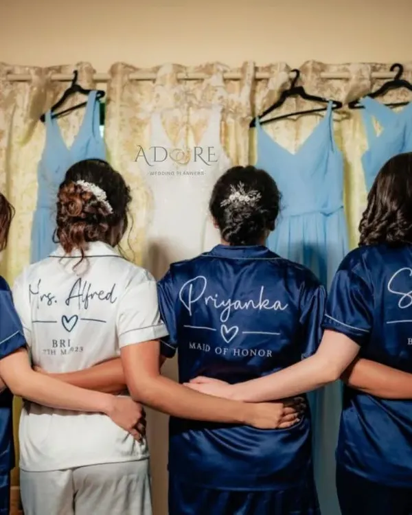 The bride and her tribe. We love planning spinster parties and getting-ready moments, complete with customized satin robes for the bride and her bridesmaids.