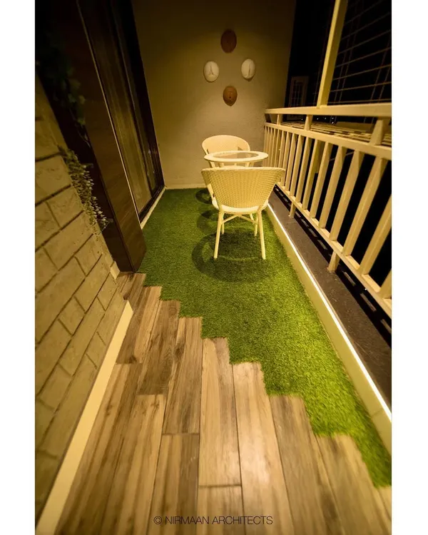 This cozy balcony is an extension of the parents' bedroom. We used a combination of wood-finish flooring and artificial grass to create a small, private garden retreat for morning tea.