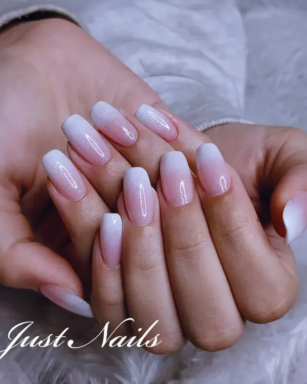 The perfect baby boomer manicure. This design features a seamless pink-to-white ombre on elegant, oval-shaped nails for a clean and classic look.
