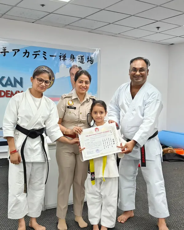 A young student proudly receives her yellow belt certificate from DCP Tanu Sharma. It is wonderful to have supportive parents and respected community members encouraging our kids.