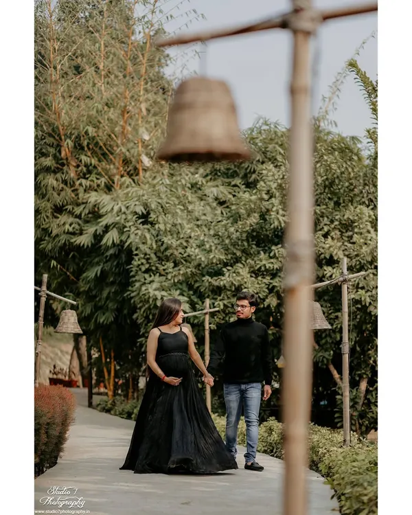 A quiet walk together, hand in hand. These candid-style moments during an outdoor couple's maternity shoot capture the journey you're on together in a relaxed, natural setting.