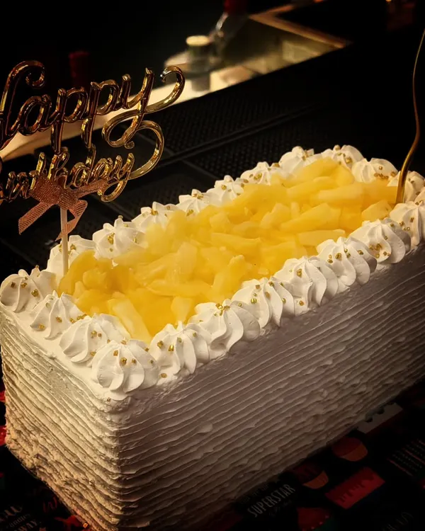 My all-time favourite pineapple cake, ready for a birthday party. This rectangular cake is topped with plenty of pineapple chunks and has a light, fluffy texture that's always a hit.