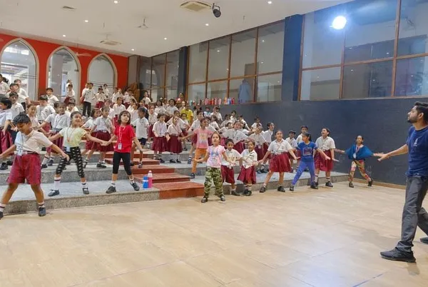 Leading a large group of students in a rehearsal for their school's annual day. My goal is to make big group choreography feel personal and fun for every single student on stage.