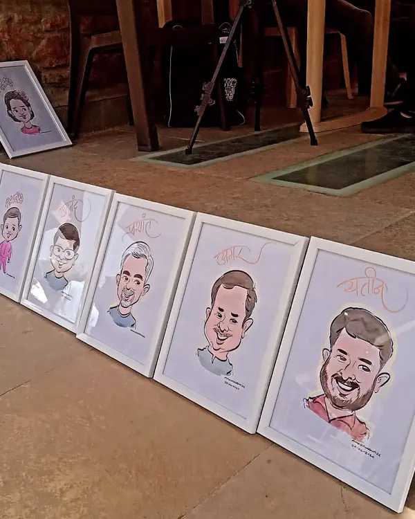 A lineup of my framed caricatures, ready to be gifted at an event. Presenting the art in a clean, white frame makes it a professional and cherished keepsake.