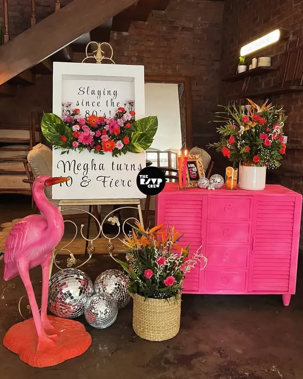 'Slaying since the 80's!' This gorgeous welcome sign for a 40th birthday was designed with a shadow box filled with vibrant fresh flowers.