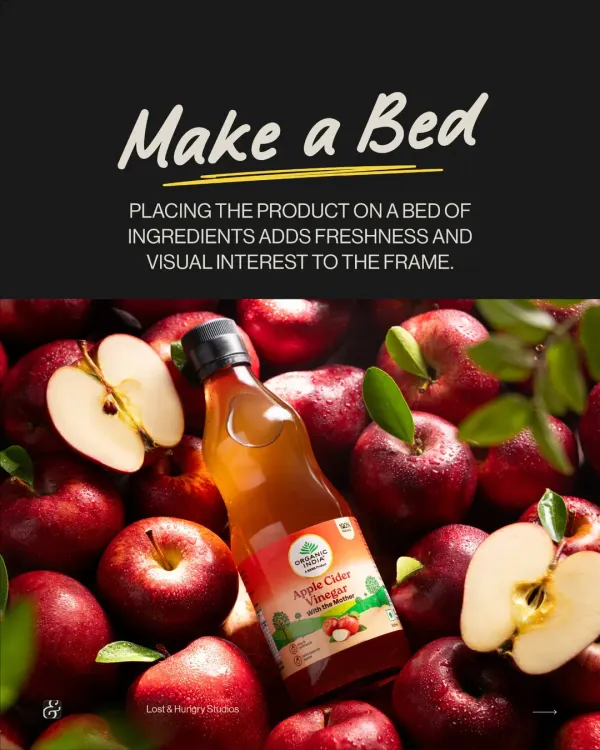 A bottle of Organic India's Apple Cider Vinegar resting on a bed of fresh apples. This simple concept immediately communicates that the product is made from real, natural ingredients.