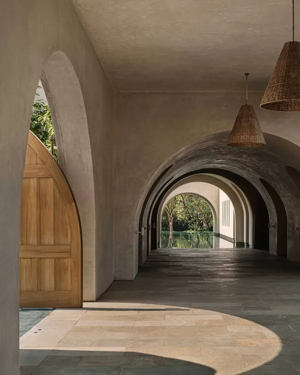 This arched peristyle at the DUA Villa captures our philosophy of creating tranquil spaces that flow into the landscape. The interplay of light, shadow, and natural textures creates a passage that is both a physical and sensory experience, blurring the line between inside and out.