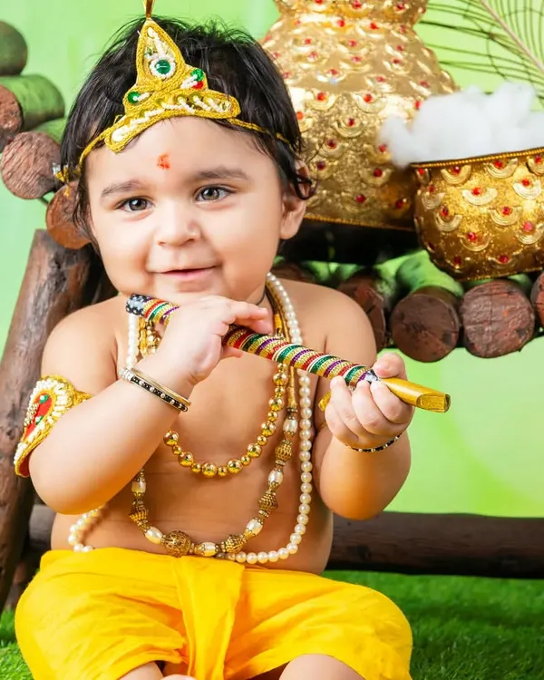 My little Krishna celebrating Janmashtami. The detailed costume, jewelry, and pot of butter make this a truly special and festive portrait.