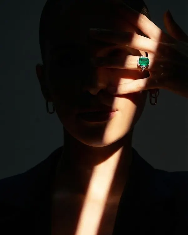 For the bride seeking a touch of colour, this exquisite natural green emerald engagement ring offers a bold and personal statement. The stone's deep hue is captured beautifully in a simple, elegant setting.