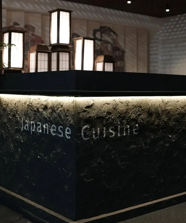 The main counter of the 'Ebisu' Japanese cuisine pop-up at the India Art Fair. We used a textured, dark stone finish with under-counter lighting and traditional Japanese lanterns to create a sophisticated focal point.