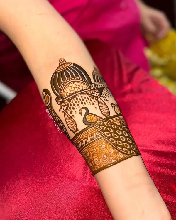 A beautiful bridal armband featuring a palace dome and a graceful peacock. This is a perfect example of architectural henna art.