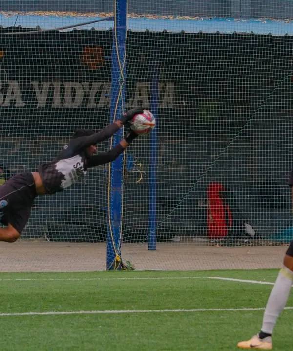 This is the moment we train for. A full-stretch, diving save during a high-intensity goalkeeping drill on our professional turf. We build reflexes, courage, and technique to make our keepers a formidable last line of defense.