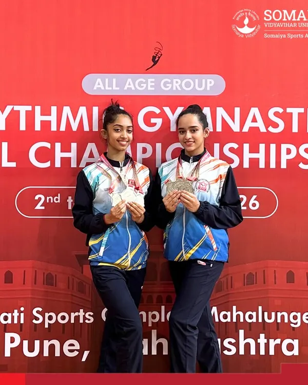 Rhythmic gymnasts Sneha Subodh Mahajan and Sharayu Nilesh Patil display their triple silver medals from the National Championship.