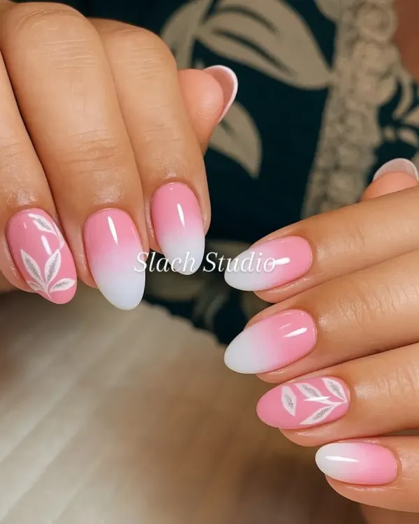 A soft and feminine design featuring a pink to white ombre effect on almond-shaped nails. I added a simple, hand-painted white leaf design to the accent nails for a touch of nature-inspired elegance.