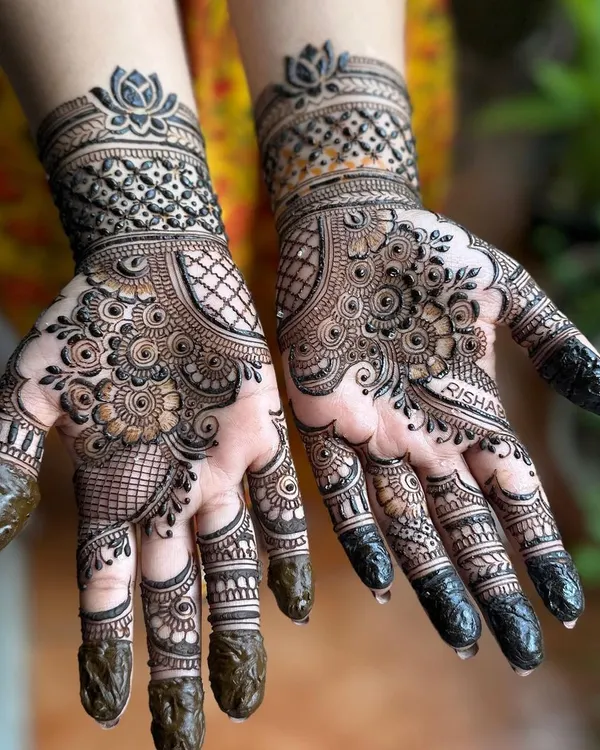 A beautiful, full-hand design perfect for Karwa Chauth. This style combines floral elements with grid patterns and a lotus cuff, creating a rich and traditional look.
