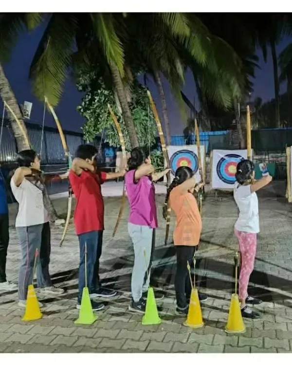 A full shooting line during one of our evening summer camp sessions. Students learn together in a structured environment, practicing their aim on the targets.