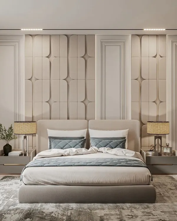 A masterclass in symmetry and texture, this bedroom features a stunning upholstered accent wall behind a custom bed. Matching bedside tables and lamps complete this hotel-like luxury suite, designed for ultimate comfort and style.