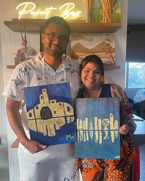 A couple proudly displays their unique gold leaf paintings. It's so fun to see how two people can start with the same idea and end up with such different, personal creations.