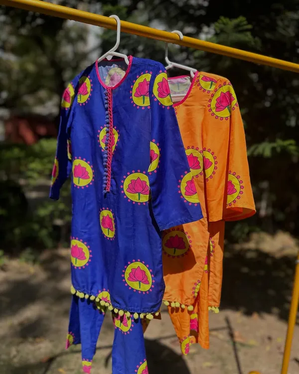 A look at my summer-ready kurta sets in royal blue and orange. The vibrant lotus print and pom-pom trim are designed to be playful and fun.