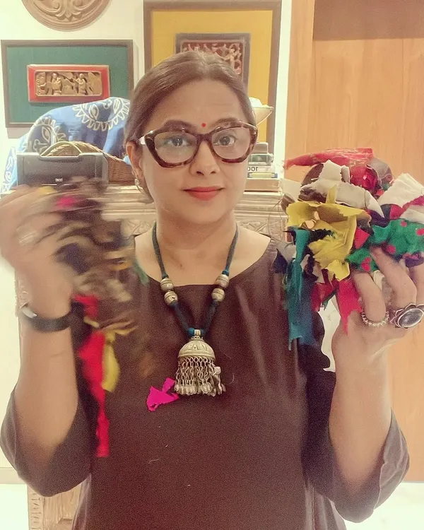 This is me in my studio, holding scraps of fabric that will be upcycled into an improv quilt. For me, there is great satisfaction in creating beautiful things from what would otherwise be waste.