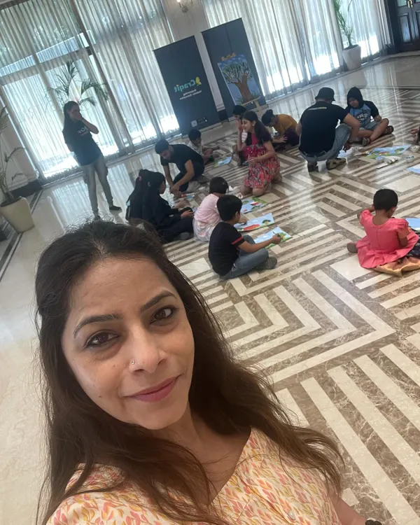 A selfie from our summer workshop at Central Park. In the background, you can see the kids busy with an arts and crafts session, a relaxing and creative part of our day.