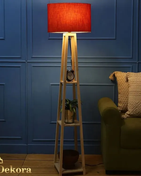 This version of our wooden shelf lamp features a bold red lampshade, adding a vibrant pop of color to the room. The functional shelves provide a perfect spot for a small clock, plant, and other decor items.