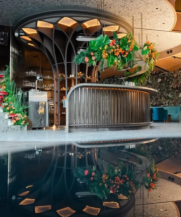 This is where brand stories come to life. For this corporate reception, I designed a "Citrus Safari" theme, creating an immersive jungle experience with a custom-built bar, tropical foliage, and a striking water feature that reflected the entire scene. The goal was to build a complete environment that guests would not just see, but feel.