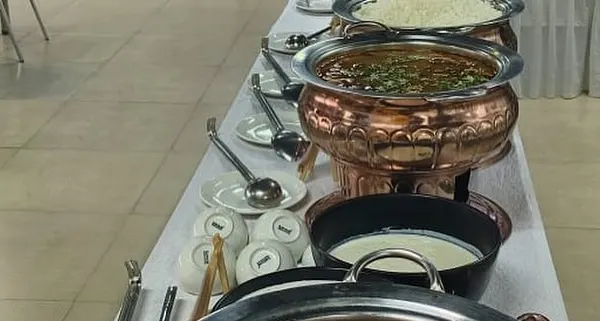 A selection of our North Indian main courses, including a rich dal and a vegetable curry, served in traditional copper pots.