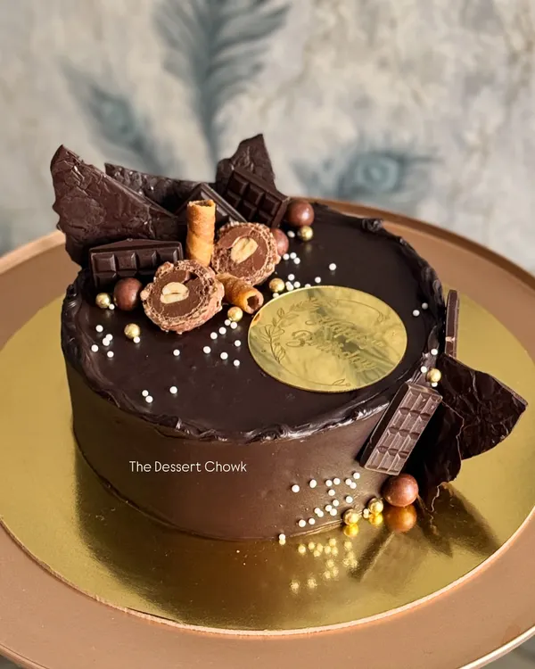 My signature Chocolate Truffle cake, loaded with chocolate shards, Ferrero Rocher, and chocolate wafer rolls. It's pure indulgence in every bite.