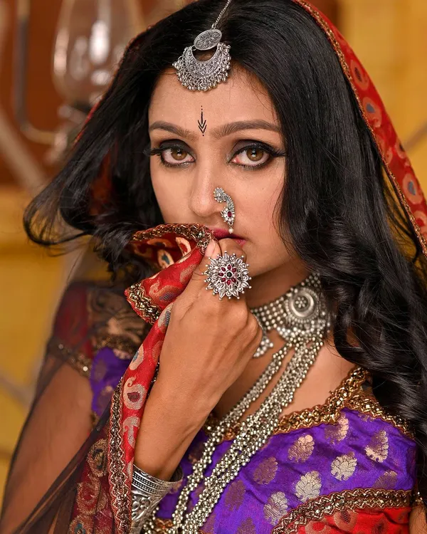 This is from our Rajasthani folk-themed set. We used a warm, earthy-toned backdrop, pottery props, and traditional silver jewelry to create an authentic and evocative story of love and longing.