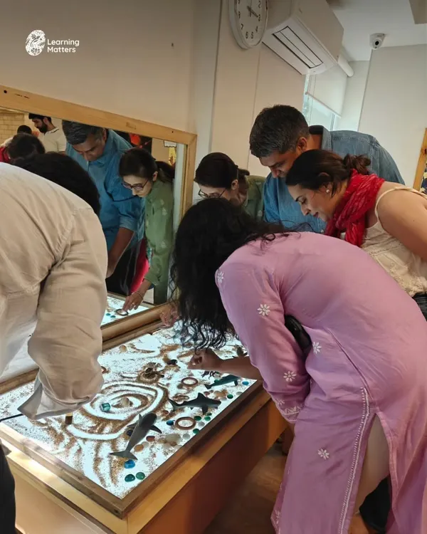 Play is not just for children. During a parent event, adults rediscover their own sense of wonder at the light table, connecting with the materials and gaining a deeper understanding of how their children learn.