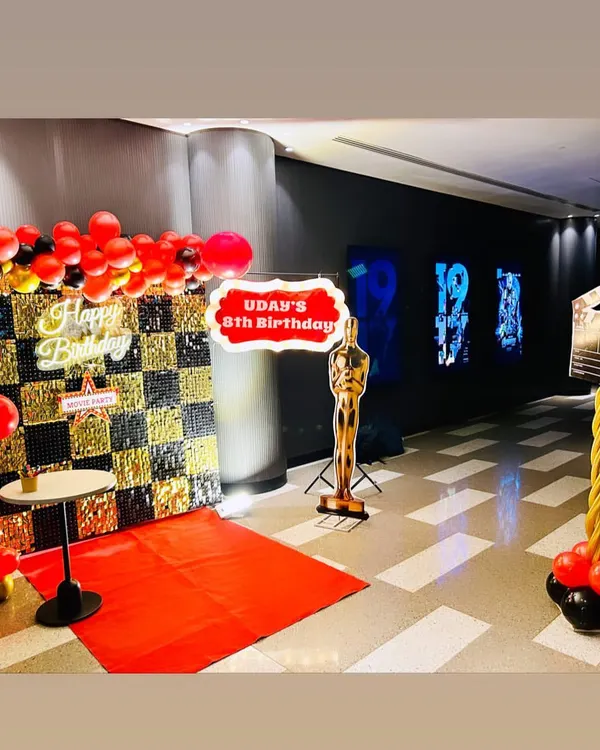 We brought the glamour of the movies to an 8th birthday with this Bollywood theme decoration. The setup included a red carpet entrance, a custom birthday sign, an Oscar statue prop, and a movie clapperboard for the perfect themed photo op.