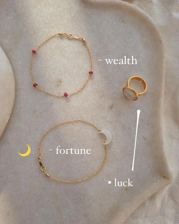 For wealth and passion, I recommend Ruby. This image shows my 'árvat' Ruby Baati Bracelet and 'śaani' White Moonstone Saturn Ring. Ruby is a stone of good fortune, while Moonstone attracts abundance.