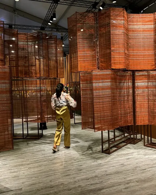 We believe in creating spaces that are living narratives. This installation for 'India Everywhere' is a testament to that belief, a gleaming river of copper, aluminum, and cotton meticulously handwoven in our studio. It is a sculptural form that embodies the confluence of India's rich history and its modern aspirations.