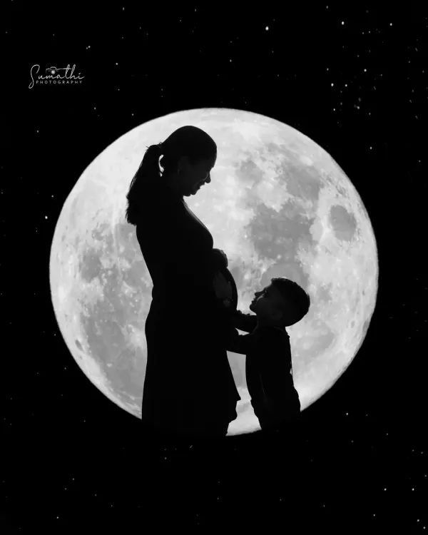 A beautiful and tender silhouette of a mother and her child against a full moon. This shot captures the magical bond between them as they anticipate the arrival of a new family member.
