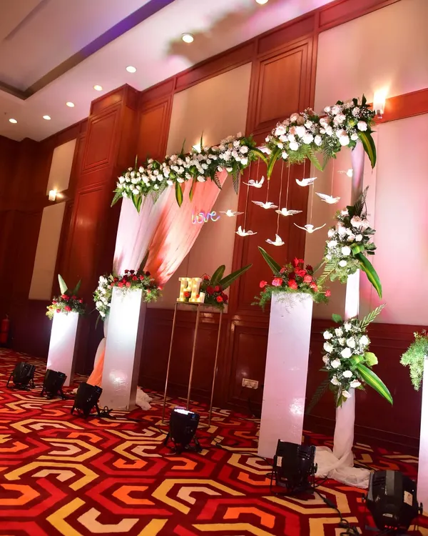 An elegant entrance arch for a Sangeet night. We used white flowers, hanging bird props, and soft lighting to create a dreamy and romantic welcome for the guests.