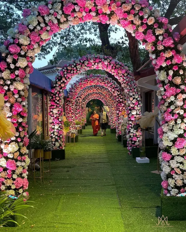 A breathtaking entrance for a Mamera ceremony. I created a long tunnel of floral arches using shades of pink and white, making for a truly grand and unforgettable welcome for the guests.