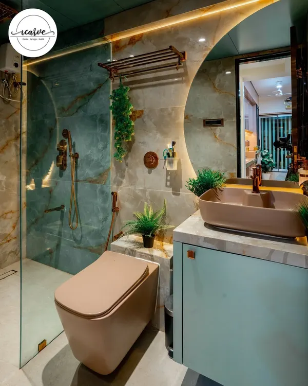 A luxurious bathroom featuring green onyx-style tiles and brushed copper fittings. The large, backlit round mirror and mint-colored vanity with a vessel sink create a stunning focal point.