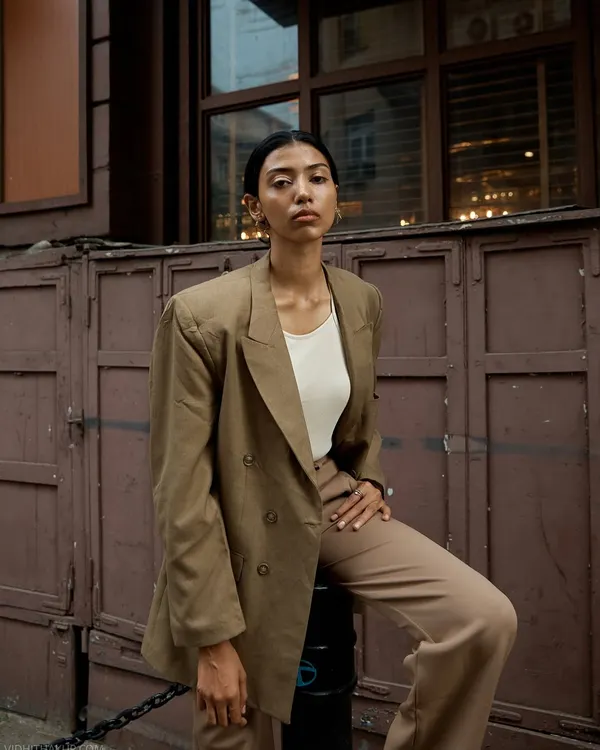 An outdoor portrait session in Mumbai. The earthy tones of the suit and the rustic urban background create a cohesive and stylish look that feels grounded and confident.