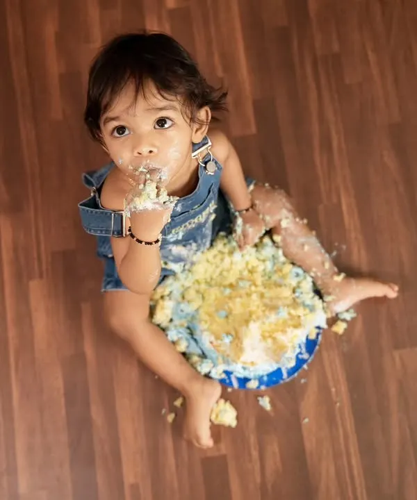 A classic top-down view of a baby enjoying a cake smash session. This is all about letting them have fun and getting messy for some unforgettable photos.
