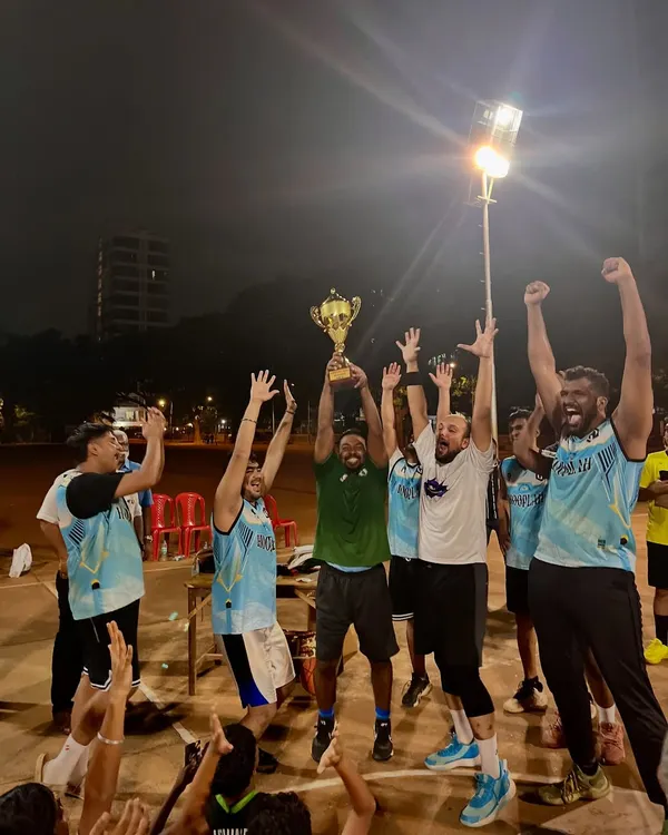 That championship feeling. The men's division winners celebrating their hard-fought victory with the trophy held high.