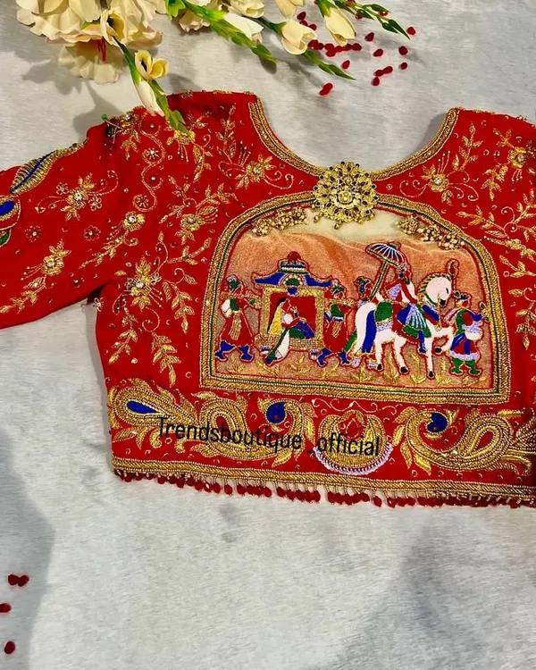 This is one of my favorite creations, a traditional Dolly Palaki bridal blouse. The entire wedding procession is brought to life with detailed aari and zardosi embroidery, telling a beautiful story right on the fabric.