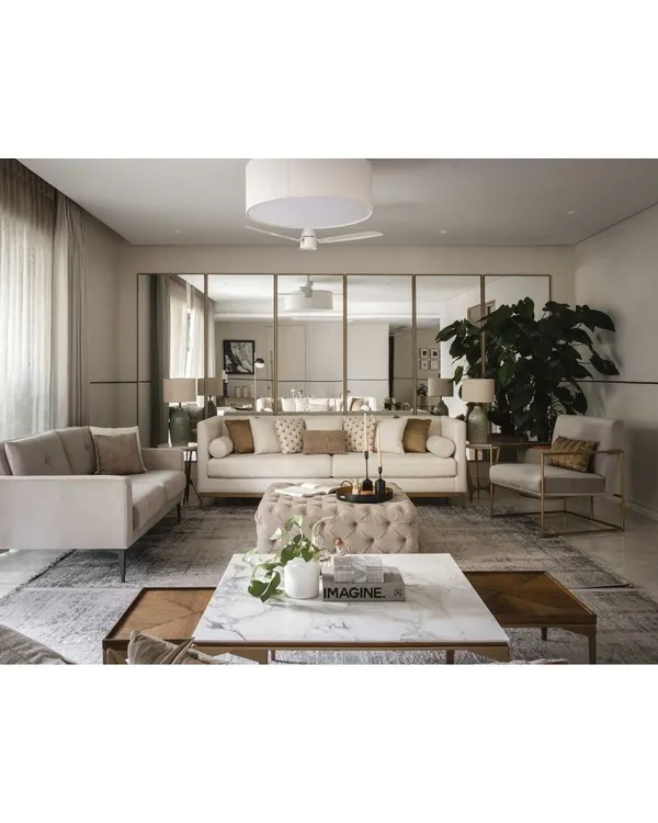 This living area embodies modern simplicity and warmth. We used a wall of floor-to-ceiling mirrors to make the space feel larger and brighter, reflecting the neutral tones of the plush, comfortable sofas.