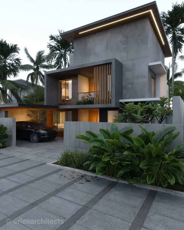 A residence in Palakad featuring a powerful concrete form with a recessed wooden screen. The design uses integrated lighting along the roofline to highlight its clean, geometric shape.